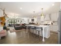 Bright, open-concept living space with hardwood floors, modern lighting, and a comfortable seating area at 3135 Bluebird Ln, Decatur, GA 30032