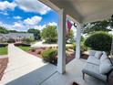 Covered front porch featuring comfortable seating and charming neighborhood views at 3804 Bay Orchard Lane, Loganville, GA 30052