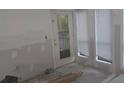 Unfinished room featuring a door to the outside and many windows for natural light at 3828 Woodridge Way, Tucker, GA 30084