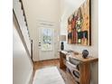 Bright foyer featuring hardwood floors, console table, and a staircase with natural light at 132 Cornerstone Pl, Woodstock, GA 30188
