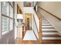 Welcoming foyer with hardwood floors, staircase, and stylish console table under painting at 132 Cornerstone Pl, Woodstock, GA 30188