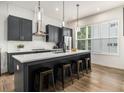 Stylish kitchen features gray cabinetry, a center island with seating, and modern pendant lighting at 2016 Bixby Byway Se Dr, Atlanta, GA 30317