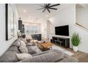 Open-concept living room featuring modern decor, a ceiling fan and seamless flow into the kitchen at 2016 Bixby Byway Se Dr, Atlanta, GA 30317