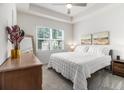 Bright main bedroom featuring a tray ceiling, a large window and neutral decor at 2016 Bixby Byway Se Dr, Atlanta, GA 30317
