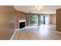 Bright living room featuring a fireplace, neutral paint, and access to the outdoor patio at 3396 Misty Harbour Trl, Doraville, GA 30340