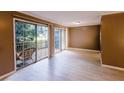 Bright living room with sliding glass doors to outdoor patio, natural light, and new flooring at 3396 Misty Harbour Trl, Doraville, GA 30340