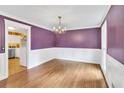 Stylish dining room featuring hardwood floors, wainscoting, and a chandelier, perfect for Gathering gatherings at 3914 Granger Dr, Atlanta, GA 30341