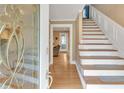 Bright entryway with hardwood floors, staircase, and decorative glass front door creating a welcoming ambiance at 3914 Granger Dr, Atlanta, GA 30341