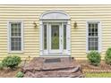 Elegant front entrance featuring a decorative glass door, sidelights, and manicured shrubs enhancing curb appeal at 3914 Granger Dr, Atlanta, GA 30341