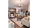 Elegant living room featuring a stone fireplace, chandelier, and plush seating area at 791 Bristol Way, Lithonia, GA 30058