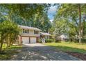 Attractive split-level home with mature trees, a two-car garage, and well-maintained lawn at 190 Windflower Trce, Roswell, GA 30075
