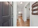 Hallway with hardwood floors, a view into the kitchen, and stylish details at 190 Windflower Trce, Roswell, GA 30075
