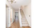 Bright hallway with wood floors, staircase and decorative lighting fixture at 1272 Whitlock Ridge Drive Sw Dr, Marietta, GA 30064
