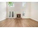 Spacious living room featuring a fireplace, wood floors, tall ceiling and French doors at 1272 Whitlock Ridge Drive Sw Dr, Marietta, GA 30064