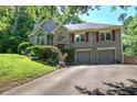 Two-story home with two-car garage, stone accents, red shutters, and lovely landscaping at 263 Bennett Farms Trl, Acworth, GA 30102
