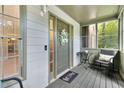 Inviting screened porch with neutral door, home sweet home doormat, and a cozy seating area at 3902 Robin Court Ct, Acworth, GA 30101
