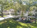 Landscaped front yard with well-maintained lawn, trees, and a charming gazebo and plantings at 504 Telfair Park, Peachtree City, GA 30269