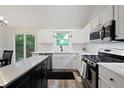 Modern kitchen featuring stainless steel appliances, bright white cabinets, and a center island at 5870 Shadewater Dr. Dr, Cumming, GA 30041