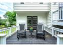 Inviting outdoor patio with rocking chairs, perfect for relaxing and enjoying the serene surroundings at 5870 Shadewater Dr. Dr, Cumming, GA 30041