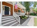 Charming brick home with a covered front porch, white railings, and an inviting entrance at 4392 Windsor Oaks Cir, Marietta, GA 30066