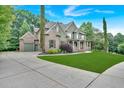 Beautiful home with three car garage with a large driveway and a well-maintained front yard at 511 Millwood Ct, Canton, GA 30114