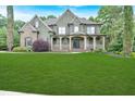 Stunning home boasts a lush green lawn, complemented by mature trees and meticulously maintained landscaping at 511 Millwood Ct, Canton, GA 30114