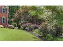 Lush front yard with colorful flowerbeds and mature landscaping at 4955 Day Lily Nw Way, Acworth, GA 30102