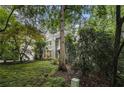 Beautiful home exterior surrounded by lush greenery and mature trees at 80 Stratford Ne Pl, Atlanta, GA 30342