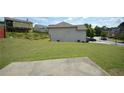 Expansive backyard with lush green grass and a concrete patio, perfect for outdoor activities and relaxation at 829 Still Hill Ln, Lawrenceville, GA 30045