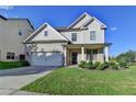 Charming two-story home featuring a brick facade, well-manicured lawn, and an attached two-car garage at 829 Still Hill Ln, Lawrenceville, GA 30045