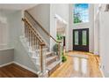 Bright foyer features hardwood floors, staircase, and a grand window above the front door at 878 Treadstone Overlook, Suwanee, GA 30024