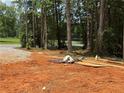 A vacant lot with trees in the background and construction materials laying around at 1100 Pleasant Grove Church Rd, Villa Rica, GA 30180