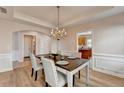 Elegant dining room with crown molding, chandelier, and seating for four at 2765 Turning Leaf Dr, Lawrenceville, GA 30044