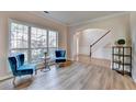 Cozy sitting room with hardwood floors and large windows offering ample natural light at 2765 Turning Leaf Dr, Lawrenceville, GA 30044
