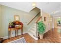Inviting entryway with hardwood floors, staircase, and decorative table with plant at 3120 Henderson Walk, Atlanta, GA 30340