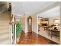 Hallway view leading to the living room, featuring hardwood floors and a staircase at 3120 Henderson Walk, Atlanta, GA 30340