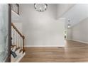 Bright foyer featuring wood floors, a staircase, and stylish lighting at 4816 Morning Chase Nw, Acworth, GA 30102