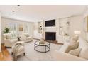 Bright and airy living room with a fireplace, built-in shelves, and neutral decor at 1151 Roxboro Ne Cv, Atlanta, GA 30324