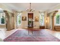 Spacious foyer features arched columns, terracotta floors, and decorative rug at 2837 N Hills Ne Dr, Atlanta, GA 30305