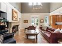 Cozy living room featuring a stone fireplace and comfortable leather furniture at 2837 N Hills Ne Dr, Atlanta, GA 30305
