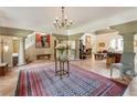 Open-concept living area with terracotta floors, columns, and fireplace at 2837 N Hills Ne Dr, Atlanta, GA 30305