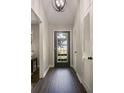 Light and bright entry way with a dark wood floor, and neutral walls at 4214 Williamsburg Dr, College Park, GA 30337