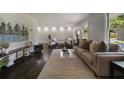 Spacious living room featuring contemporary furniture, light walls and dark floors at 4214 Williamsburg Dr, College Park, GA 30337