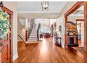Spacious foyer showcasing hardwood floors, staircase, and a view into the living room at 52 Waterside Se Dr, Cartersville, GA 30121