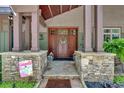Inviting front entrance with wood door, stone accents, and a welcome sign at 52 Waterside Se Dr, Cartersville, GA 30121