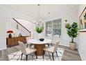 Bright dining room featuring a modern table with seating for four and contemporary decor at 6468 Panasa Ct, Tucker, GA 30084