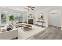 Inviting living room featuring a cozy fireplace, neutral palette, ample natural light, and modern decor at 6468 Panasa Ct, Tucker, GA 30084