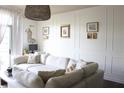 Bright living room with large sectional sofa, decorative wall art, and ample natural light at 711 Cosmopolitan Dr # 413, Atlanta, GA 30324