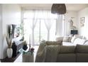 Inviting living room with comfortable seating, soft textures, and natural light streaming through large windows at 711 Cosmopolitan Dr # 413, Atlanta, GA 30324