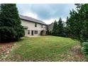 Expansive backyard featuring a lush lawn and mature trees, creating a private outdoor space at 1336 Nathan Mauldin Dr, Lawrenceville, GA 30043